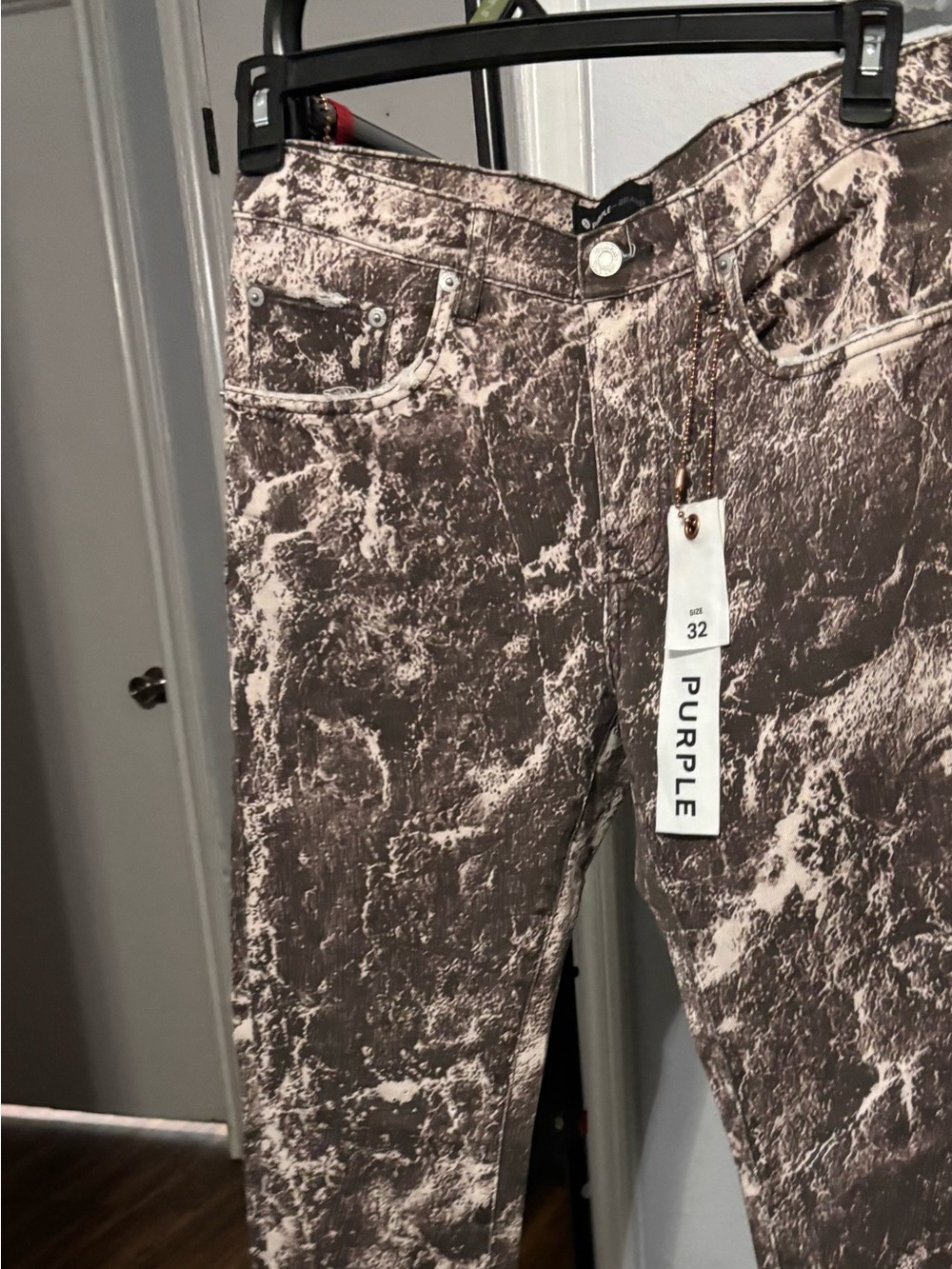 These are Purple Brand P001 slim-fit jeans featuring a white and brown marble